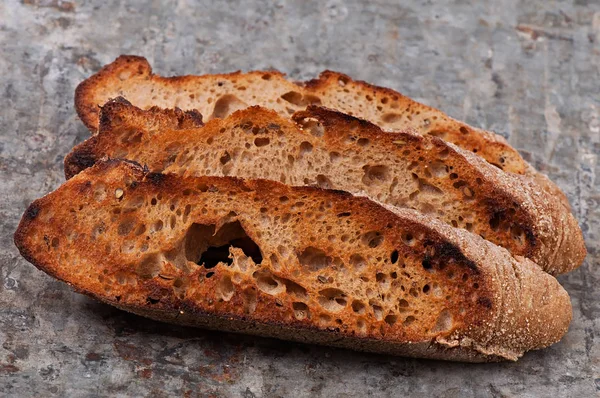 Pan tostado sobre un fondo metálico viejo . — Foto de Stock
