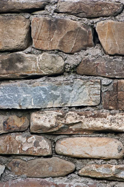 Frammento di un muro di pietra vecchio, sfondo di una pietra . — Foto Stock