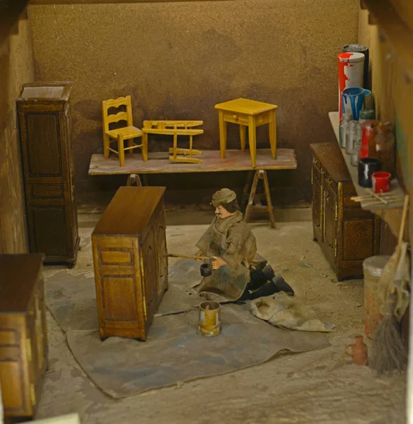 Small scale model representing carpenter making wooden furniture — Stok fotoğraf