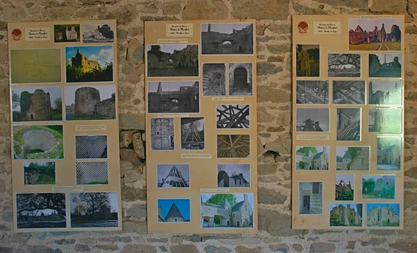 Montfort-sur-Risle, FRANCE - April 14 2019 - Boards with old photograph of Monfort Castle on stone wall — стокове фото