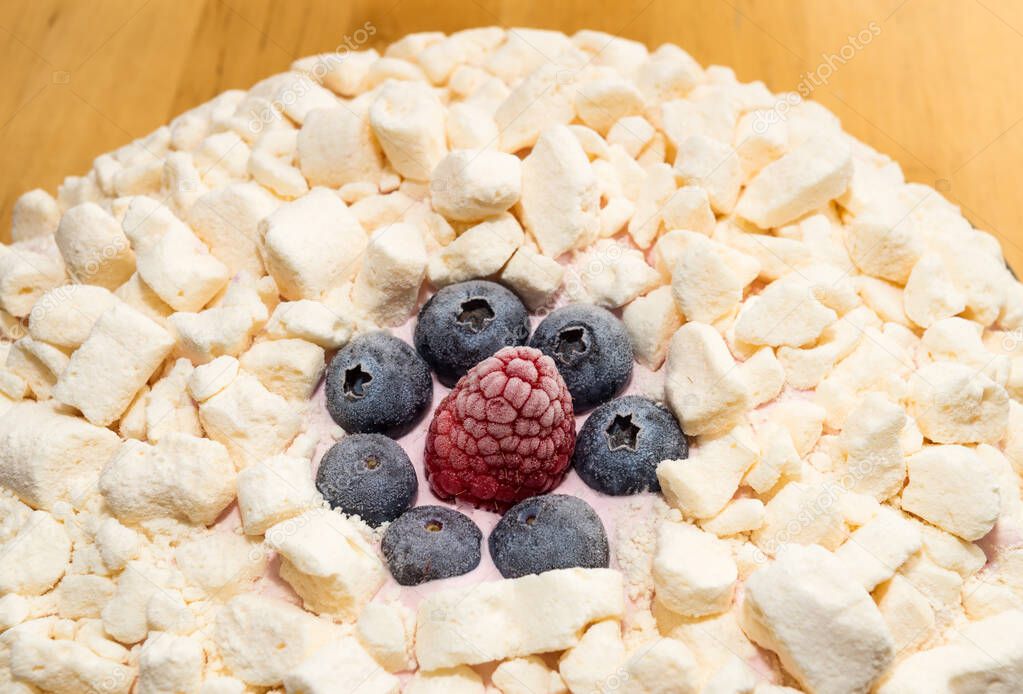 fresh meringue cake on the wooden table. closeup