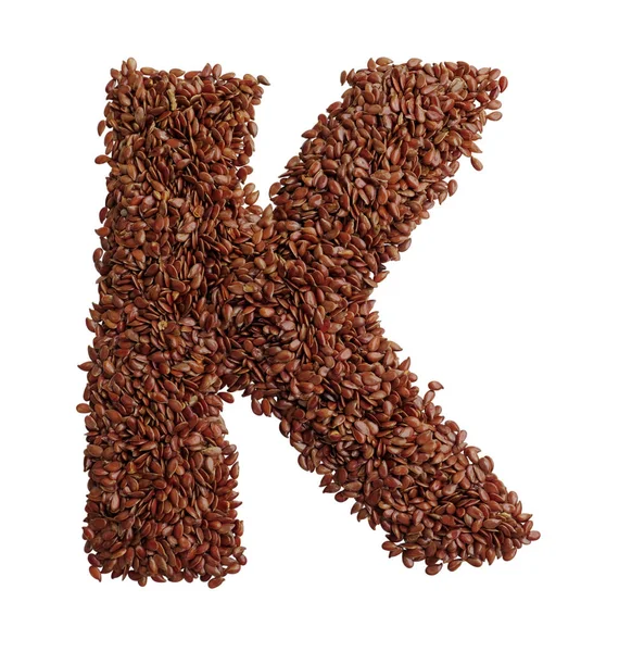 Letter K made with Linseed also known as flaxseed isolated on wh — Stock Photo, Image