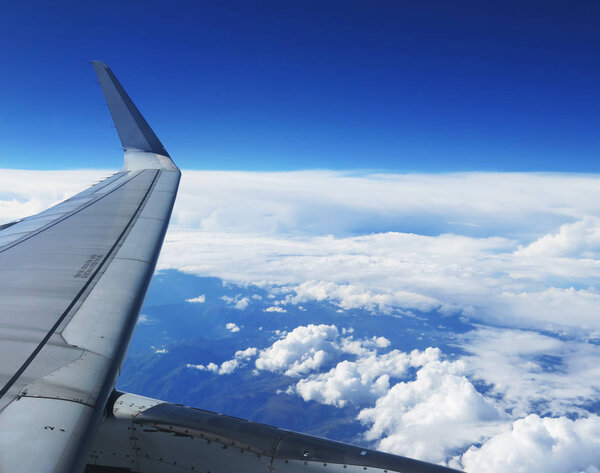 Wing of the plane on blue sky background