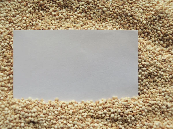 Closeup white paper on raw cous cous semolina — Stock Photo, Image