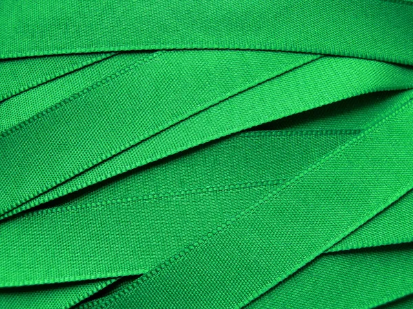 Green satin ribbon background — Stock Photo, Image