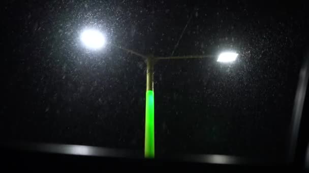 Schnee Fällt Vor Dem Hintergrund Eines Leuchtenden Laternenpfahls — Stockvideo