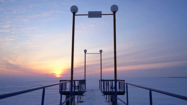 Frozen Pier Backdrop Icy Snow Covered Field Beautiful Sunset — Stock Video