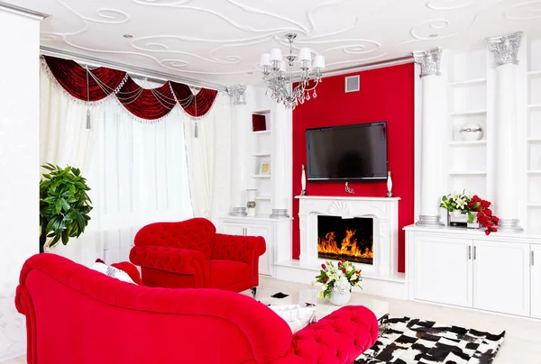 Classical red living room interior with fire place and red furni