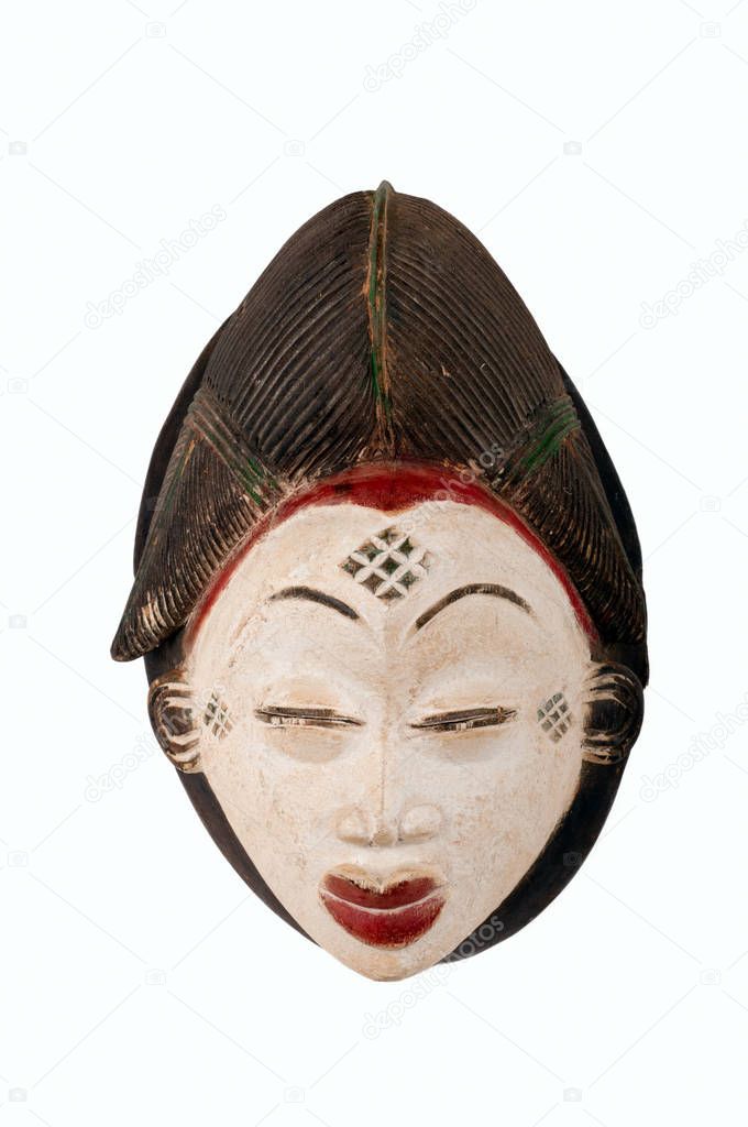 Detail of a Punu female mask from Cameroon/Africa, carved in wood with white pigment signifying anti-witchcraft powers; small splits, scrapes and cracks attest to its age/use.