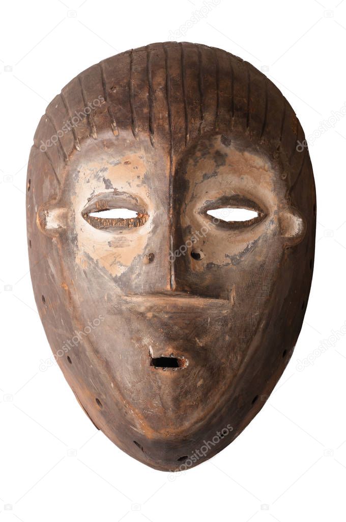An African ceremonial mask carved in wood with white pigment signifying anti-witchcraft powers, isolated on white.