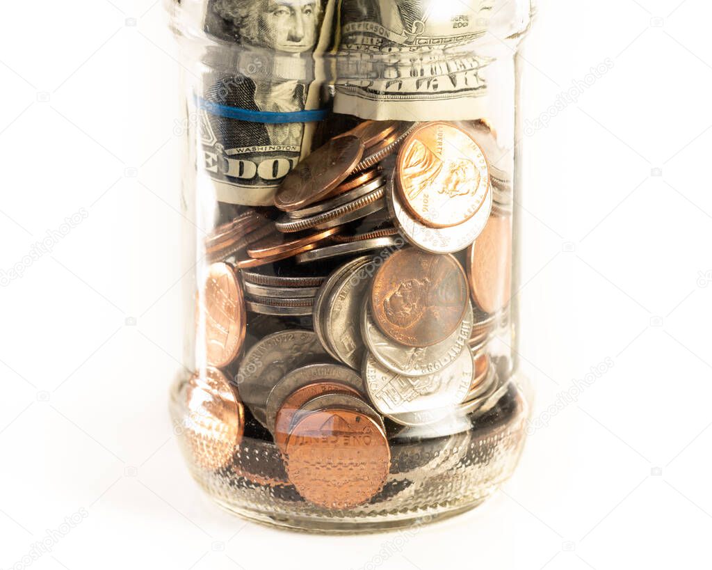 Glass jar of money isolated on a white background.