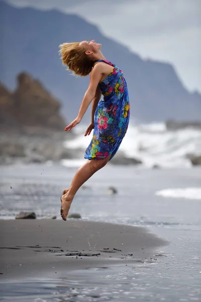 Fiatal nő jumping a strandon — Stock Fotó