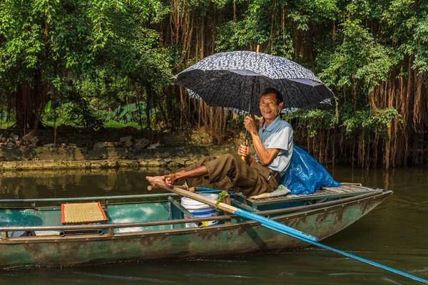 A smiling boat guide at Trang An UNESCO World Heritage site in N Stock Picture