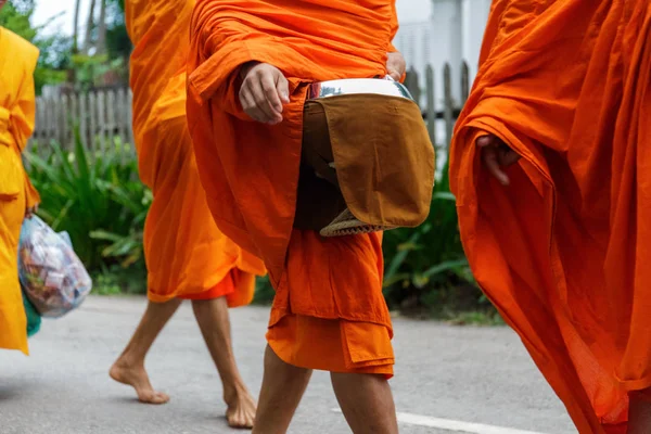 Buddhist monks collect alms in Luang Prabang, Laos Royalty Free Stock Photos