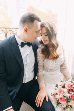  Avrupa tarzında şık bir düğün. Güzel Apara büyük bir pencerede oturuyor..