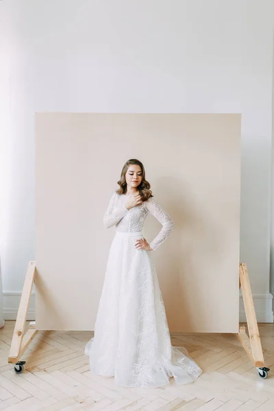 European wedding in the style of fine art. Modern bride in white interior Studio.