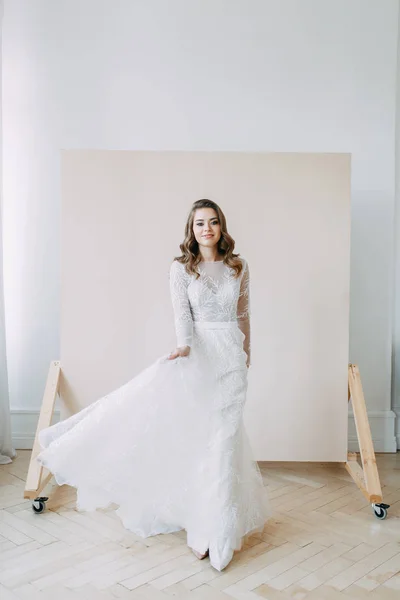 European wedding in the style of fine art. Modern bride in white interior Studio.