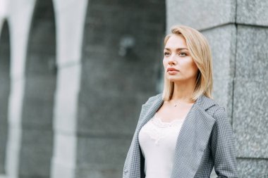 Business style, the situation in the bright office and outside. Business portrait of a beautiful girl on the street. 