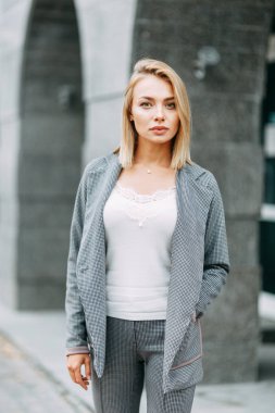 Business style, the situation in the bright office and outside. Business portrait of a beautiful girl on the street. 