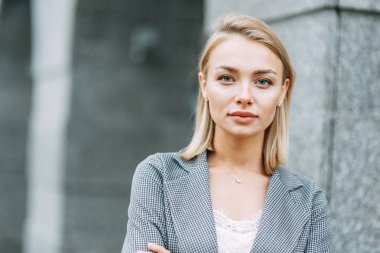 Business style, the situation in the bright office and outside. Business portrait of a beautiful girl on the street. 