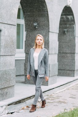 Business style, the situation in the bright office and outside. Business portrait of a beautiful girl on the street. 