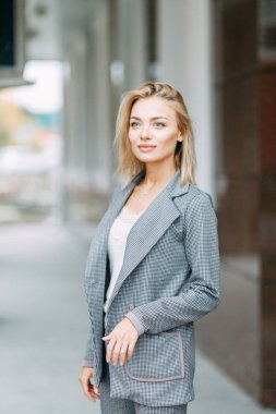 Business style, the situation in the bright office and outside. Business portrait of a beautiful girl on the street. 