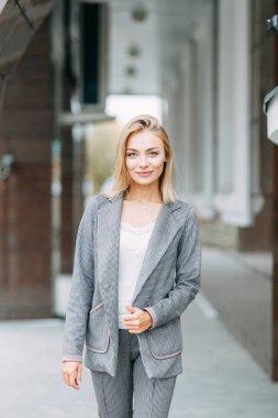 Business style, the situation in the bright office and outside. Business portrait of a beautiful girl on the street. 