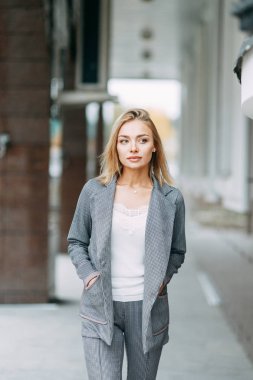 Business style, the situation in the bright office and outside. Business portrait of a beautiful girl on the street. 