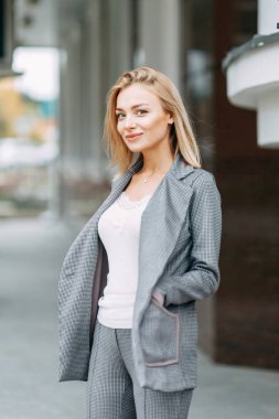 Business style, the situation in the bright office and outside. Business portrait of a beautiful girl on the street. 