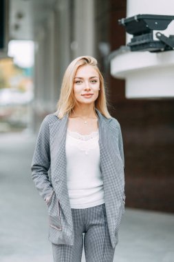 Business style, the situation in the bright office and outside. Business portrait of a beautiful girl on the street. 