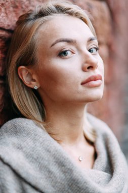 Woman in jacket emotional portrait. Beautiful smiling girl in town. 