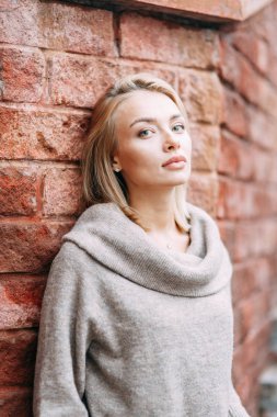 Woman in jacket emotional portrait. Beautiful smiling girl in town. 