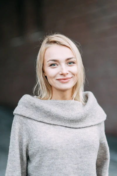 Woman in jacket emotional portrait. Beautiful smiling girl in town.