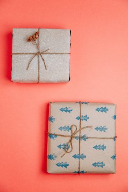 Set of boxes on pink background. Gifts in Kraft packaging with ribbon. 
