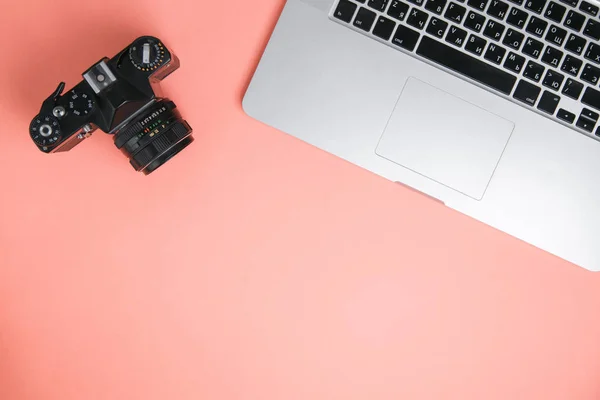 Flatley with camera, laptop and phone. Minimalist layout of the photographer on a bright background.