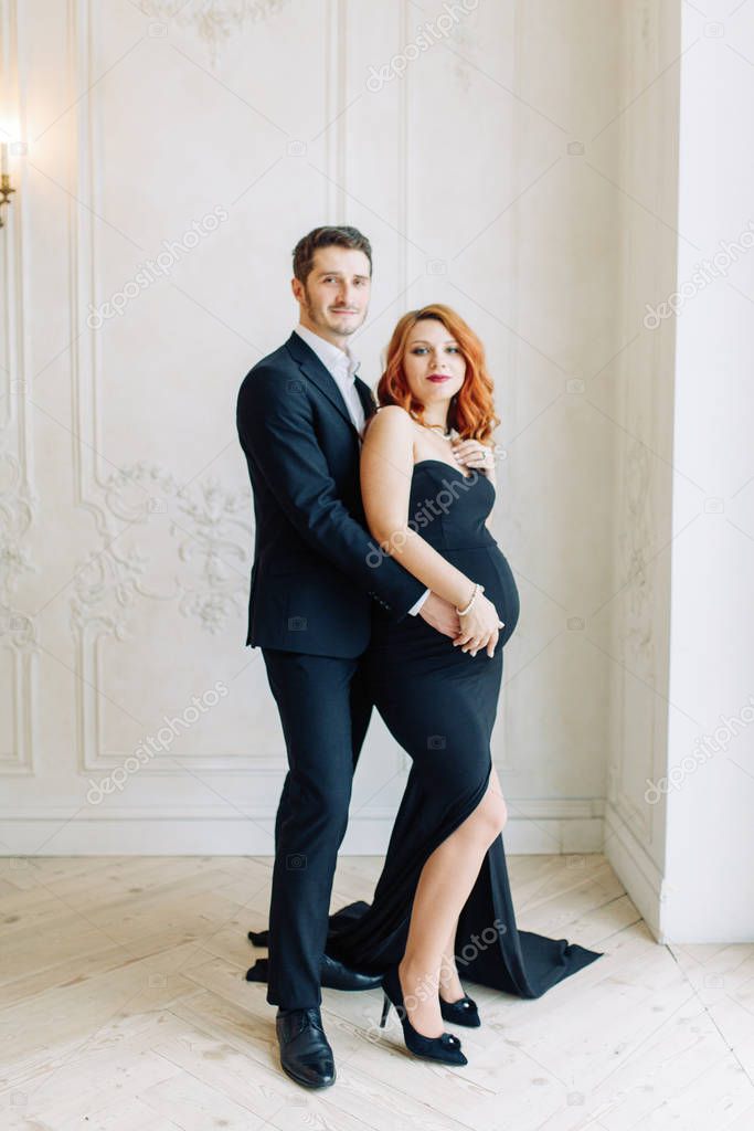  Family expecting a baby. Beautiful stylish couple in the Studio in evening images.