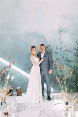 Sonbahar dekoru içinde bir düğün çifti. Odadaki güzel sanatlar tarzında bir seremoni. İç Stüdyoda düğün töreni. 