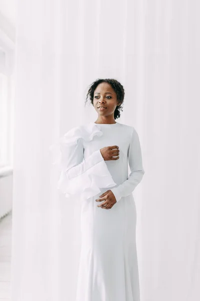 Minimalistic wedding series in European style. Stylish African bride. Concept and idea of a white wedding.