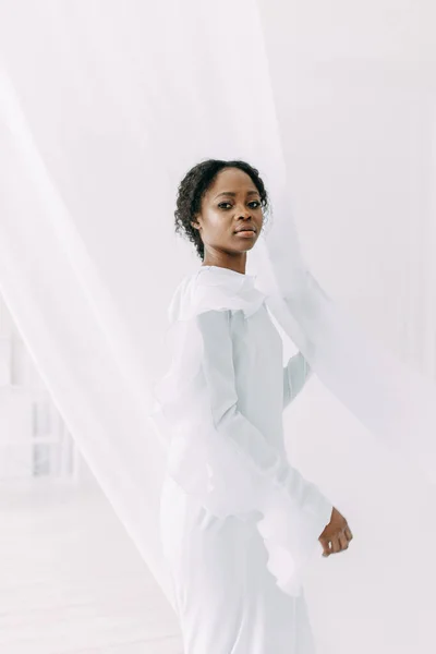 Minimalistic wedding series in European style. Stylish African bride. Concept and idea of a white wedding.
