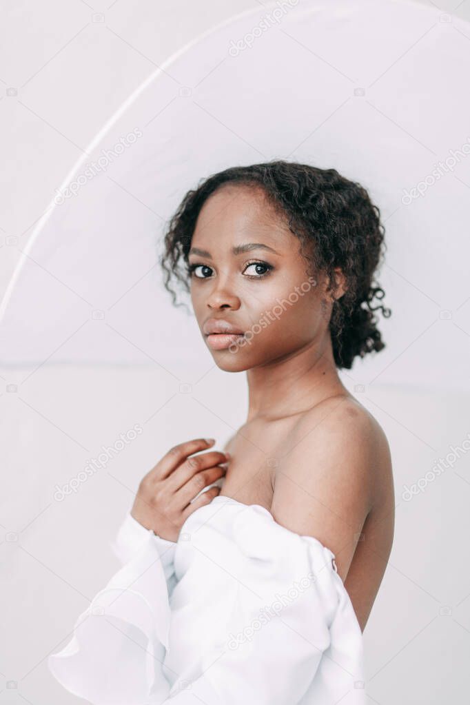 Minimalistic wedding series in European style. Stylish African bride. Concept and idea of a white wedding. 