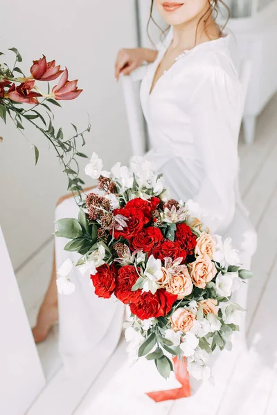 Modern trends in wedding bouquets. Bride\'s bouquet of red roses. Empty background with wedding Floristics.