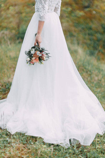  Floristics in the style of fine art in Europe. Light bouquet of peonies and roses. Modern wedding bouquet in the hands of the bride.