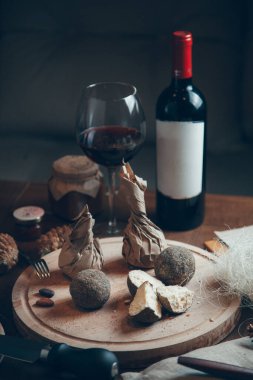 Şarap ve camla peynir kompozisyonu. Biberli kurutulmuş keçi peyniri.. 