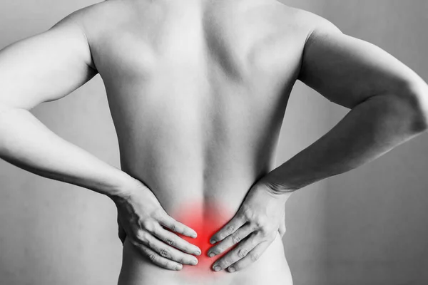 Injuries to the spine and lower back, fatigue at work. Area of the injury, the image on a clean background. Spasm on the man\'s back.