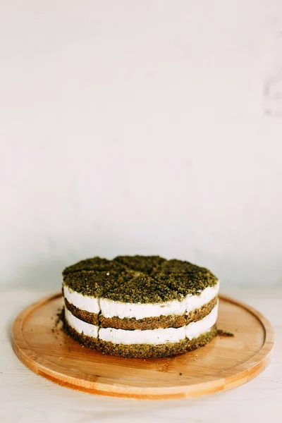Green natural spinach cake, vegan. Layer cake with spinach and cream.