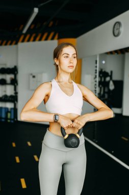 Flexibility exercises on a black background. Stretching in a dark room on a rug. Beautiful girl athlete on the floor. 