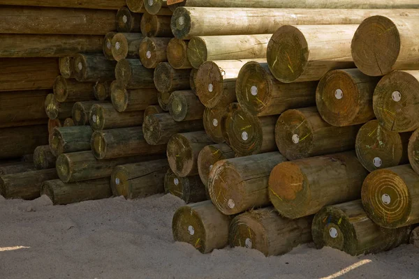 Cylindered logs on the sand — Stock Photo, Image
