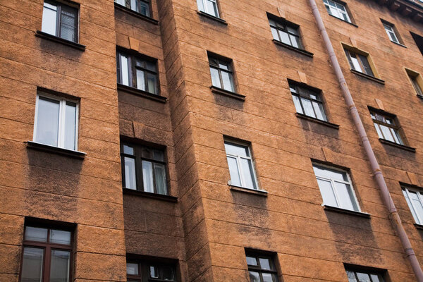 Facade of a multi-storey old house with windows