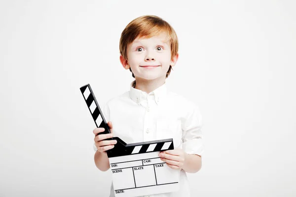 Little cute emotional boy with cinema clapper — Stock Photo, Image