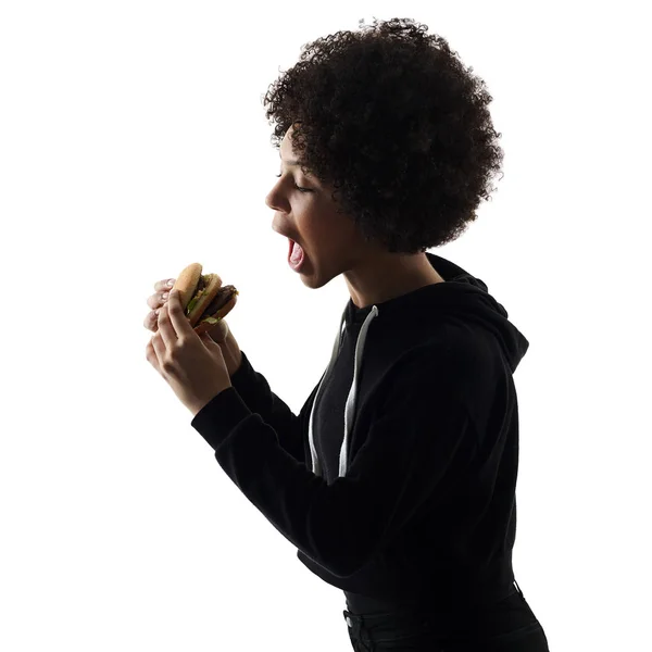 Młody nastolatek dziewczyna kobieta jedzenie hamburgerów cień sylwetka iso — Zdjęcie stockowe